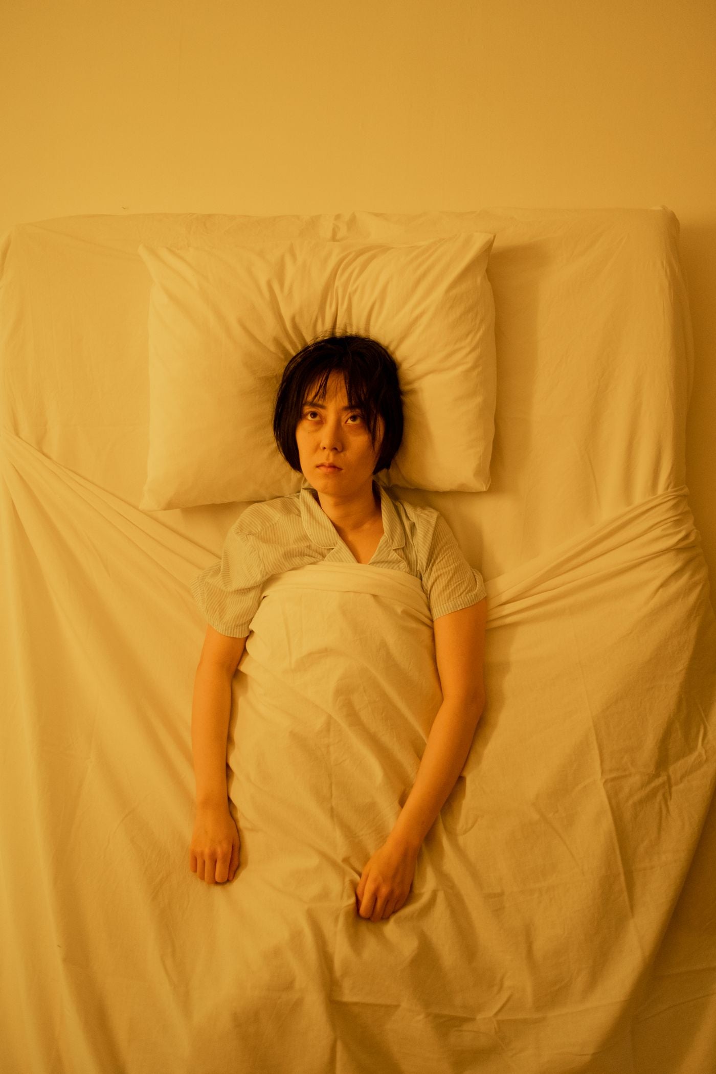 A woman lying awake with her eyes open on a pillow