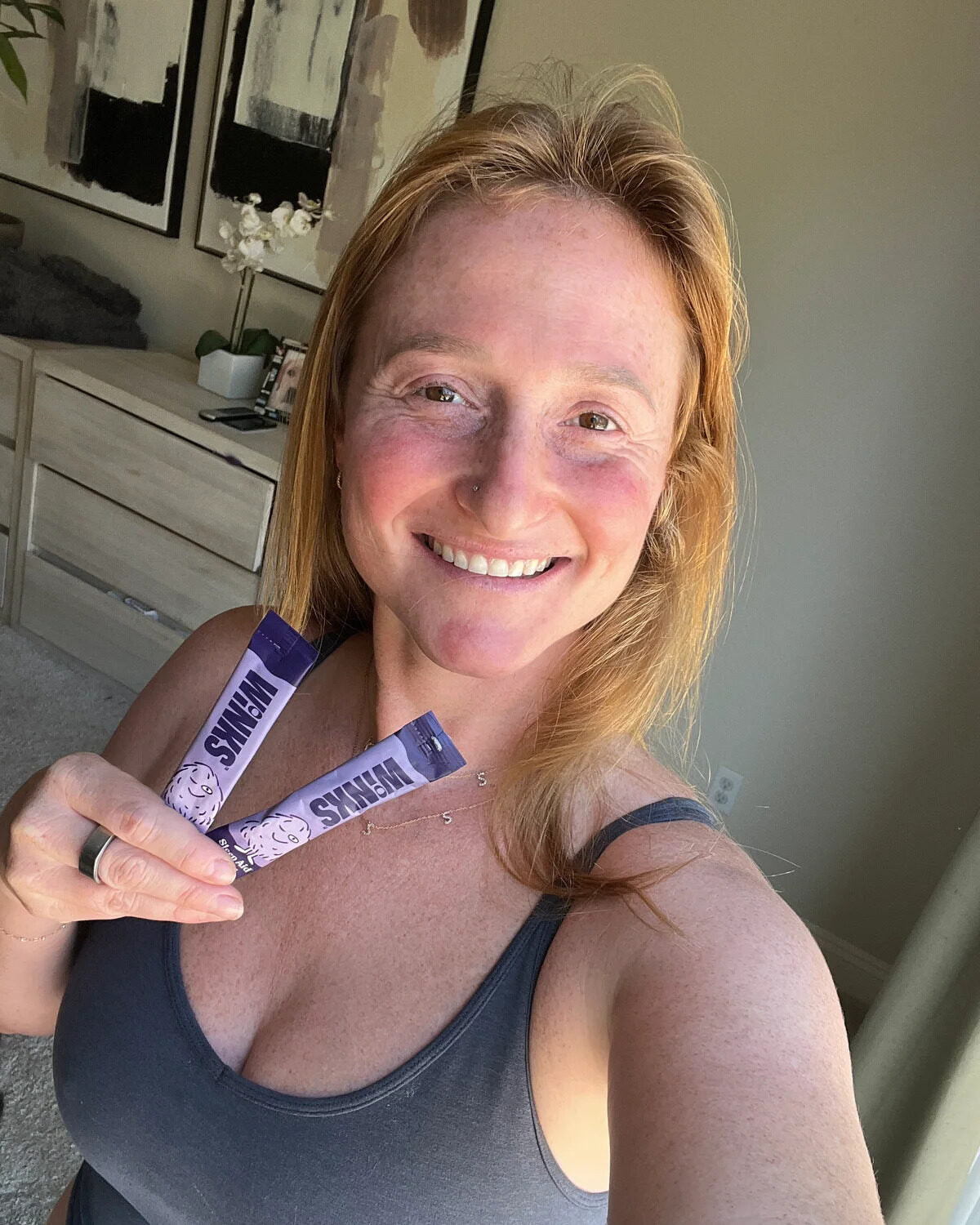 Customer holding two Winks stick packs