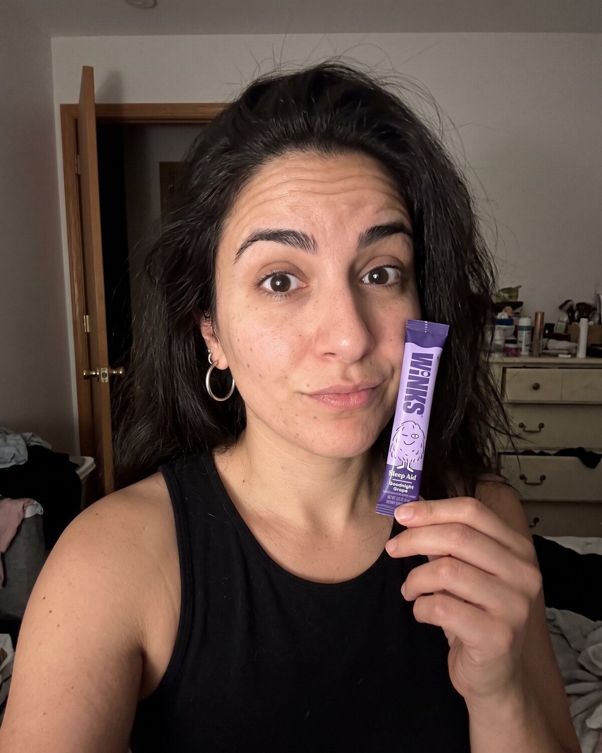 Customer holding a Winks Goodnight Grape stick pack